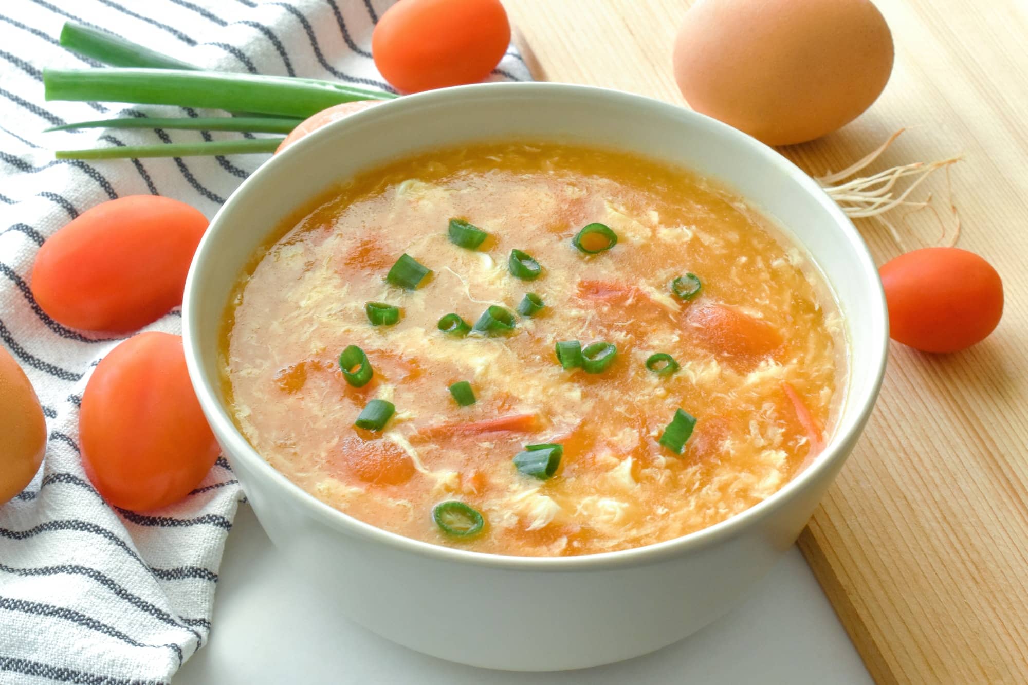 Tomato egg drop soup in a bowl. Traditional Chinese food.
