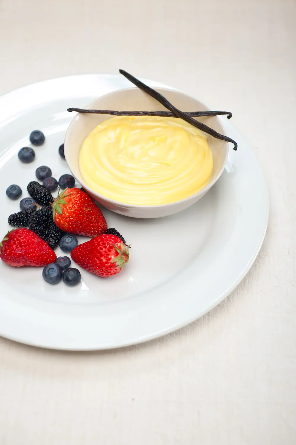 Creamy Creme Anglaise custard with fresh berries