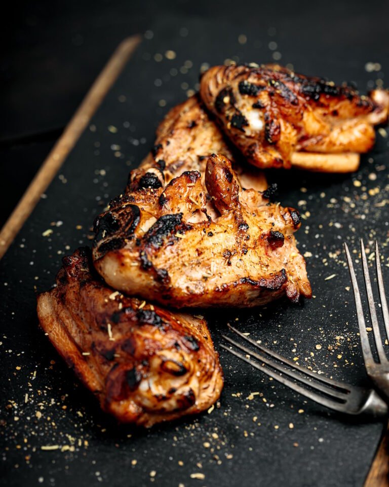 Succulent grilled chicken thighs recipe on slate
