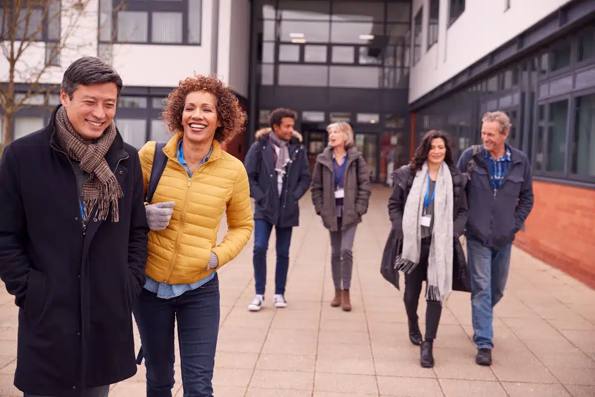 a group of three men and three women Leaving the office at the start of a trust walk.