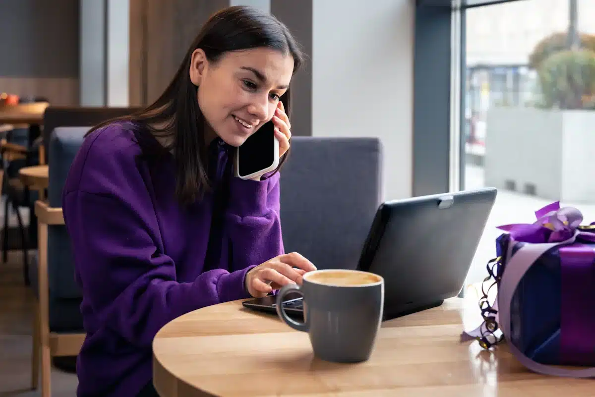 Hybrid and Teleworking young-woman-in-a-cafe-with-a-cup-of-coffee