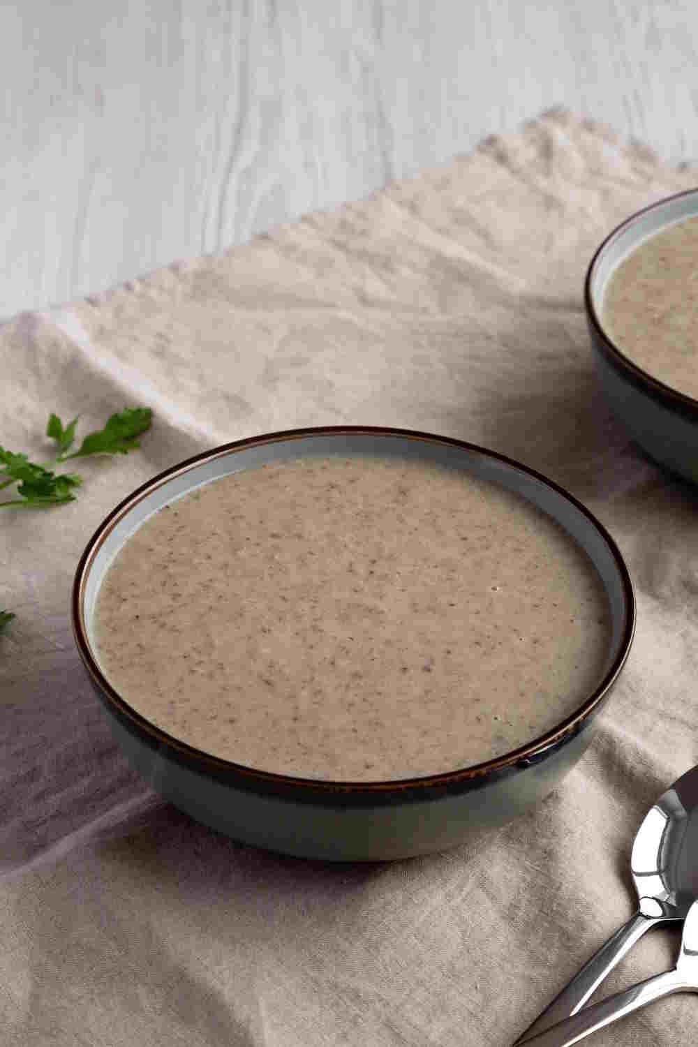 Homemade Cream of Mushroom Soup in a Bowl, side view. Copy space.