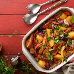 Baked sausage and vegetables, peppers, zucchini, tomatoes, red onion and eggplant with sesame and ci