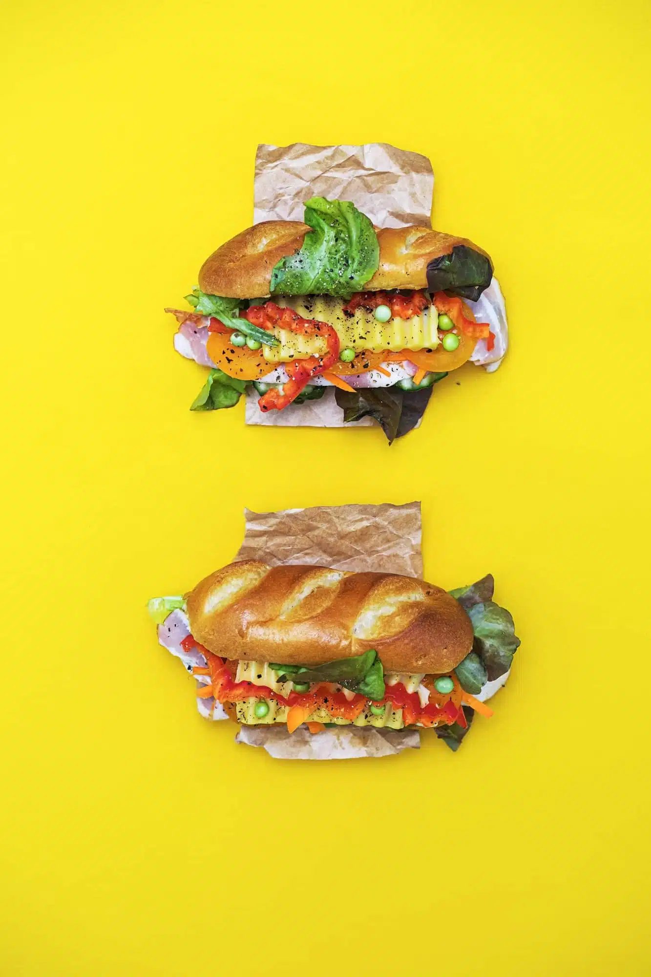 Cucumber Soup Recipes | 7 Cool Summer Pairings 3 Banh Mi Vietnamese sandwiches with various stuffing, flat lay on a yellow background