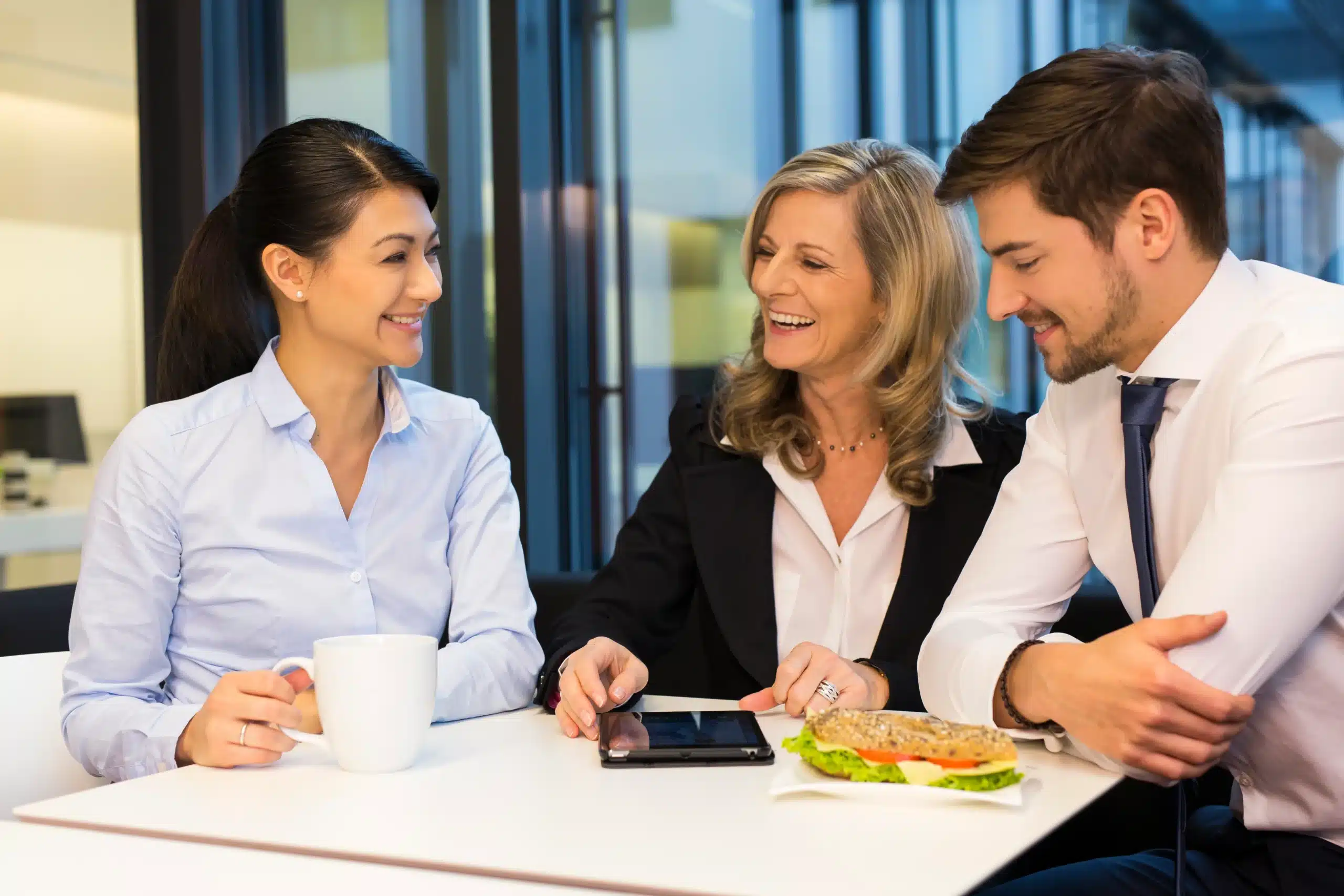 keeping the momentum of lunchtime camaraderie going with three people together at a table