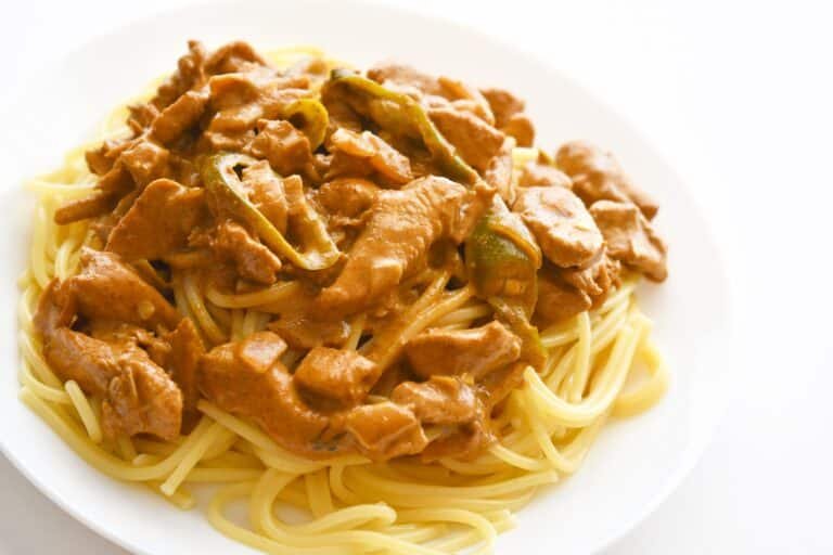 Chicken curry spaghetti on a plate. Italian and Indian mixed dishes.