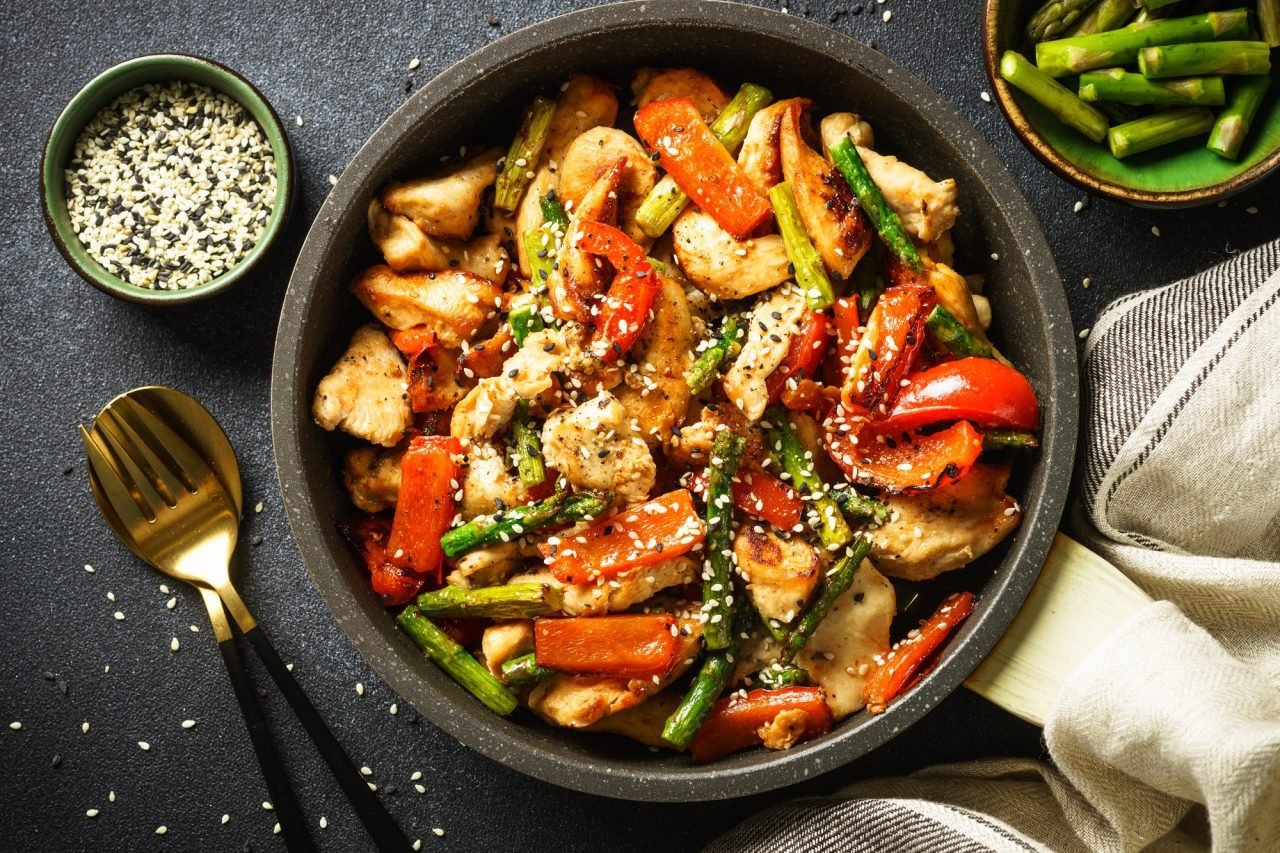 chicken-stir-fry-with-vegetables-at-stone-background