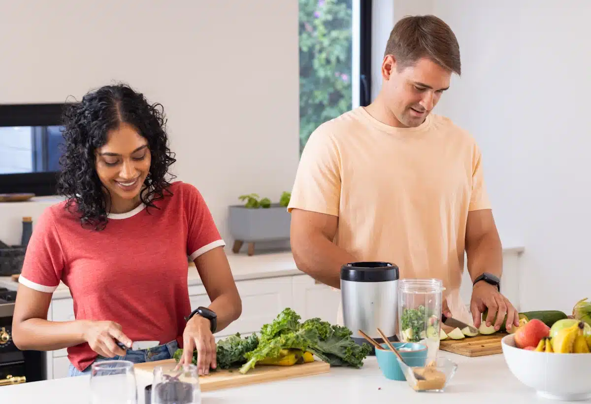 A man and a woman chopping Keto-Friendly Staples including green veggies