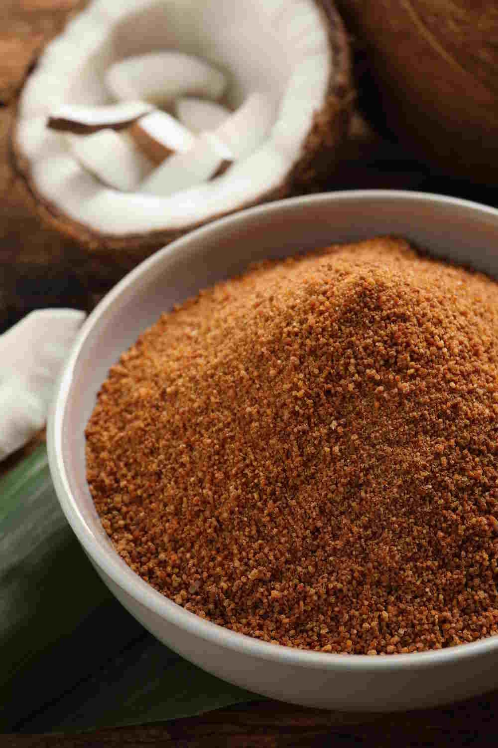 Coconut Sugar and Coconut Halves on Wooden Surface