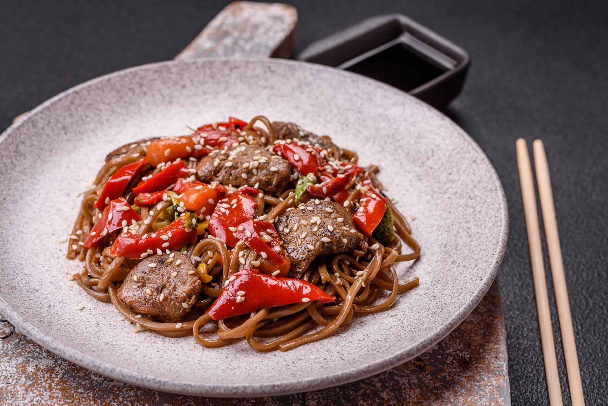 Delicious spicy Asian food soba with buckwheat noodles, beef, vegetables