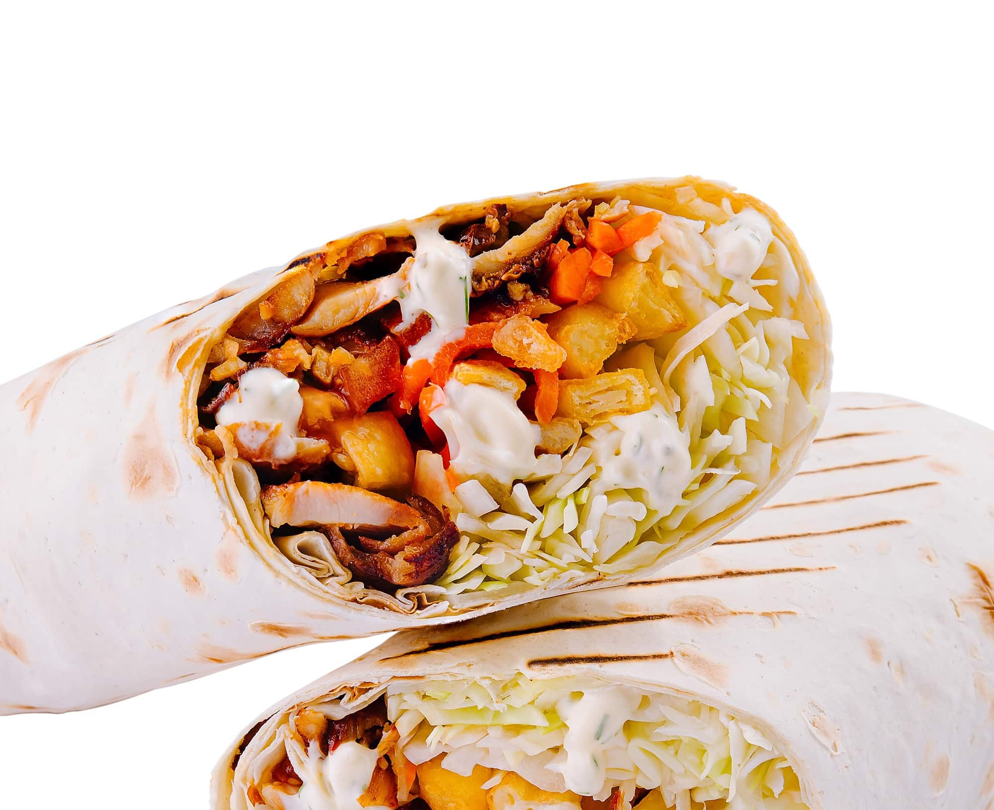 Fresh veggie wrap cut in half on white background