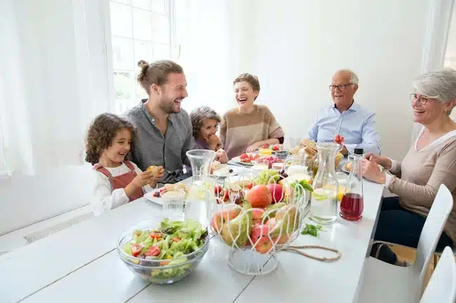 A happy extended family having lunch at home