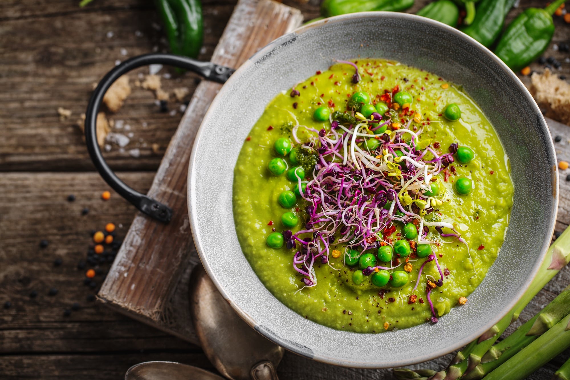 Healthy green pea soup served in bowl