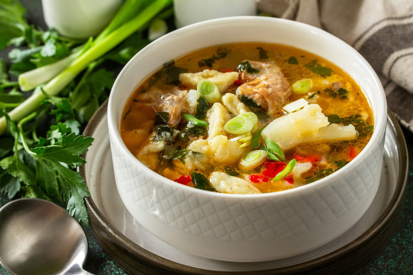 Hot delicious beef soup close-up. Homemade soup with meat, vegetables and gnocchi.