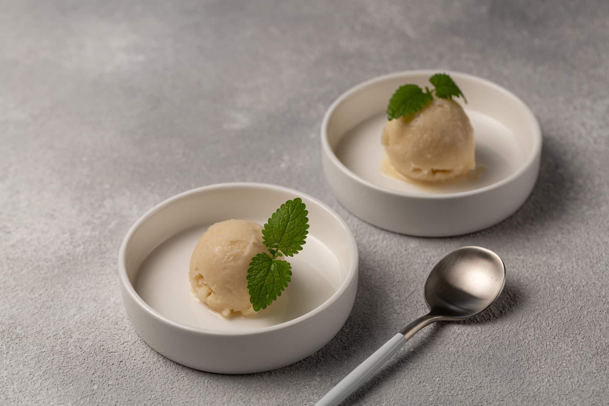 Lemon sorbet with mint leaf, refreshing ice cream, two servings of one ball