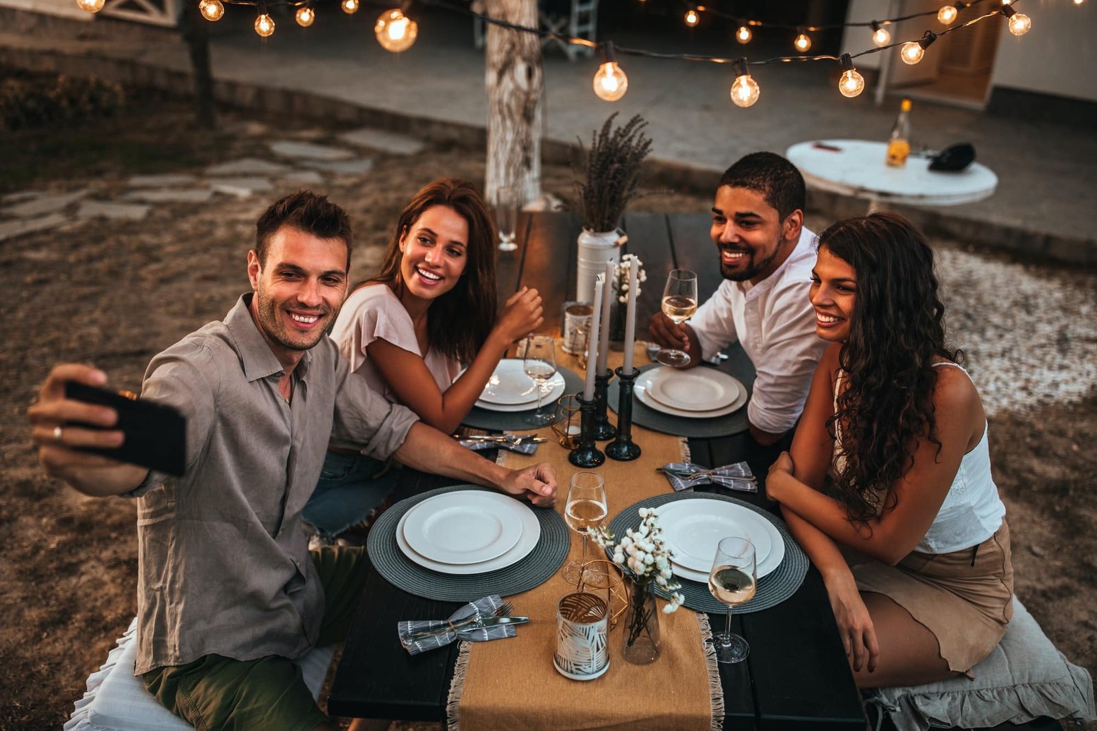 Making beautiful memories, four friends seated for lunch outdoors