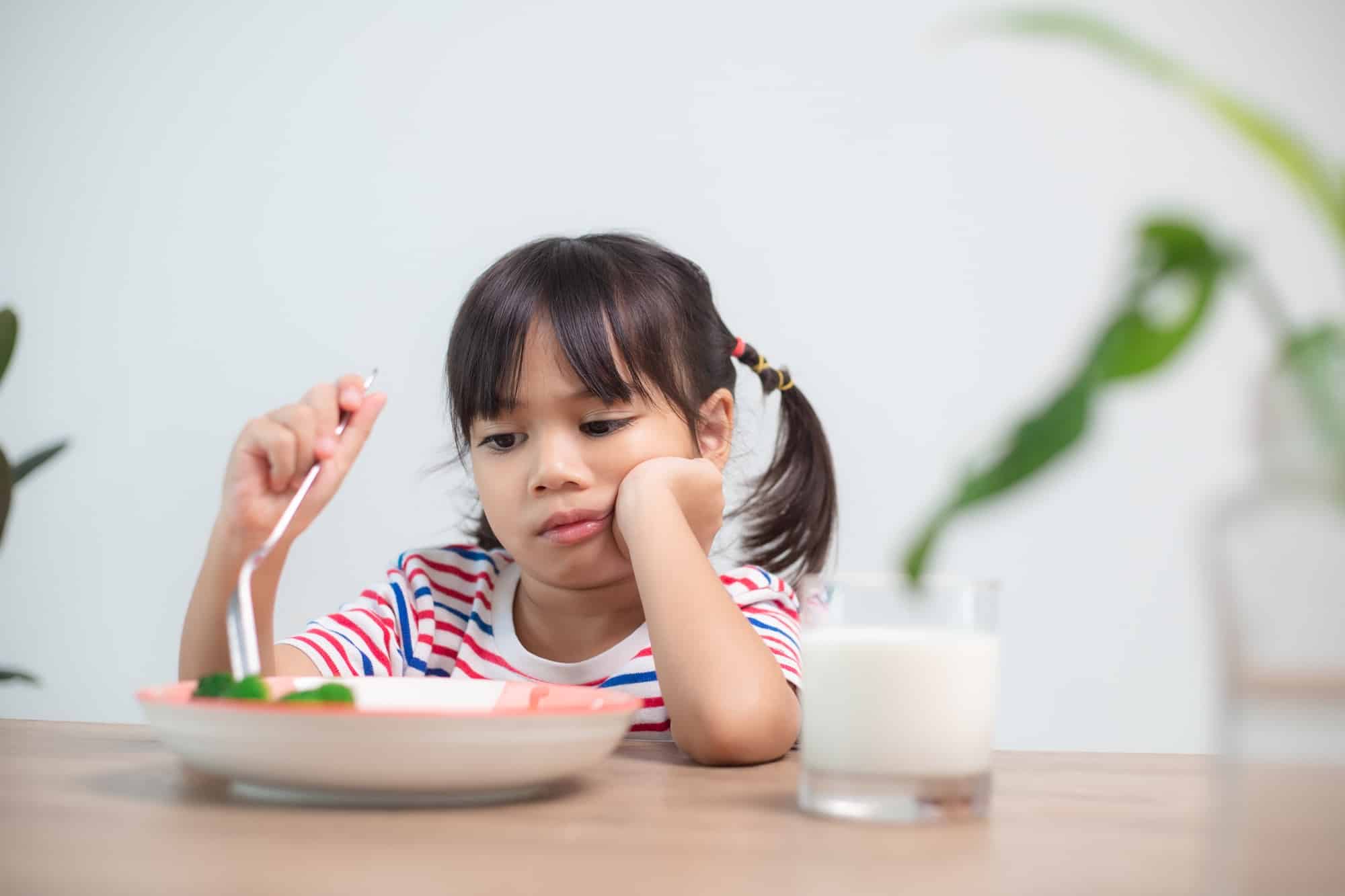Nutrition & healthy eating habits for kids concept. Children do not like to eat vegetables.
