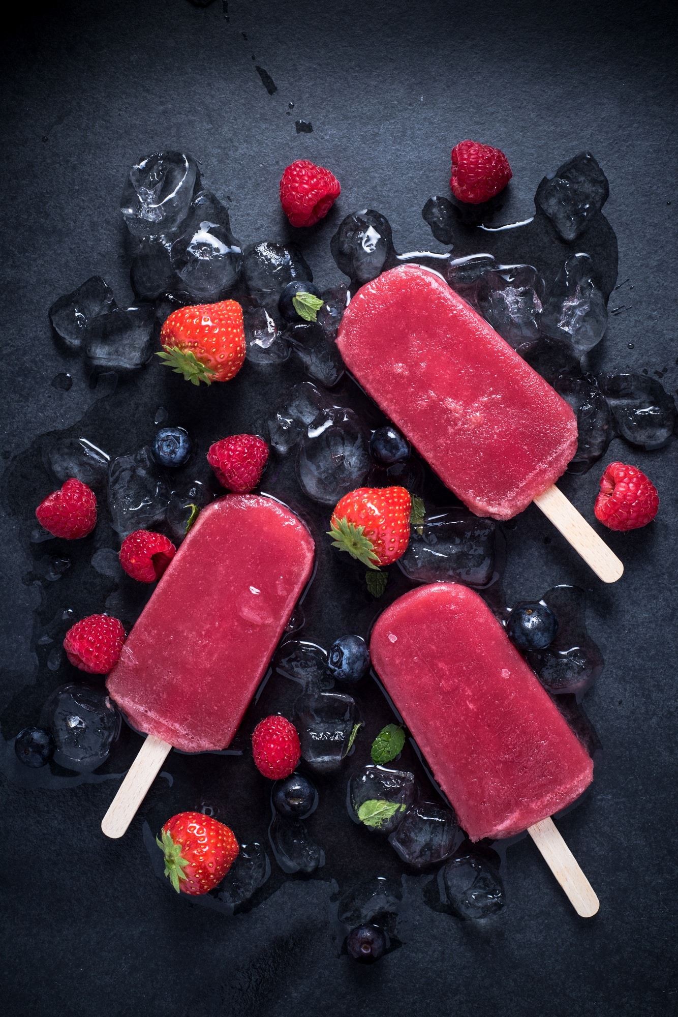 Refreshing popsicle on ice cubes and fruits