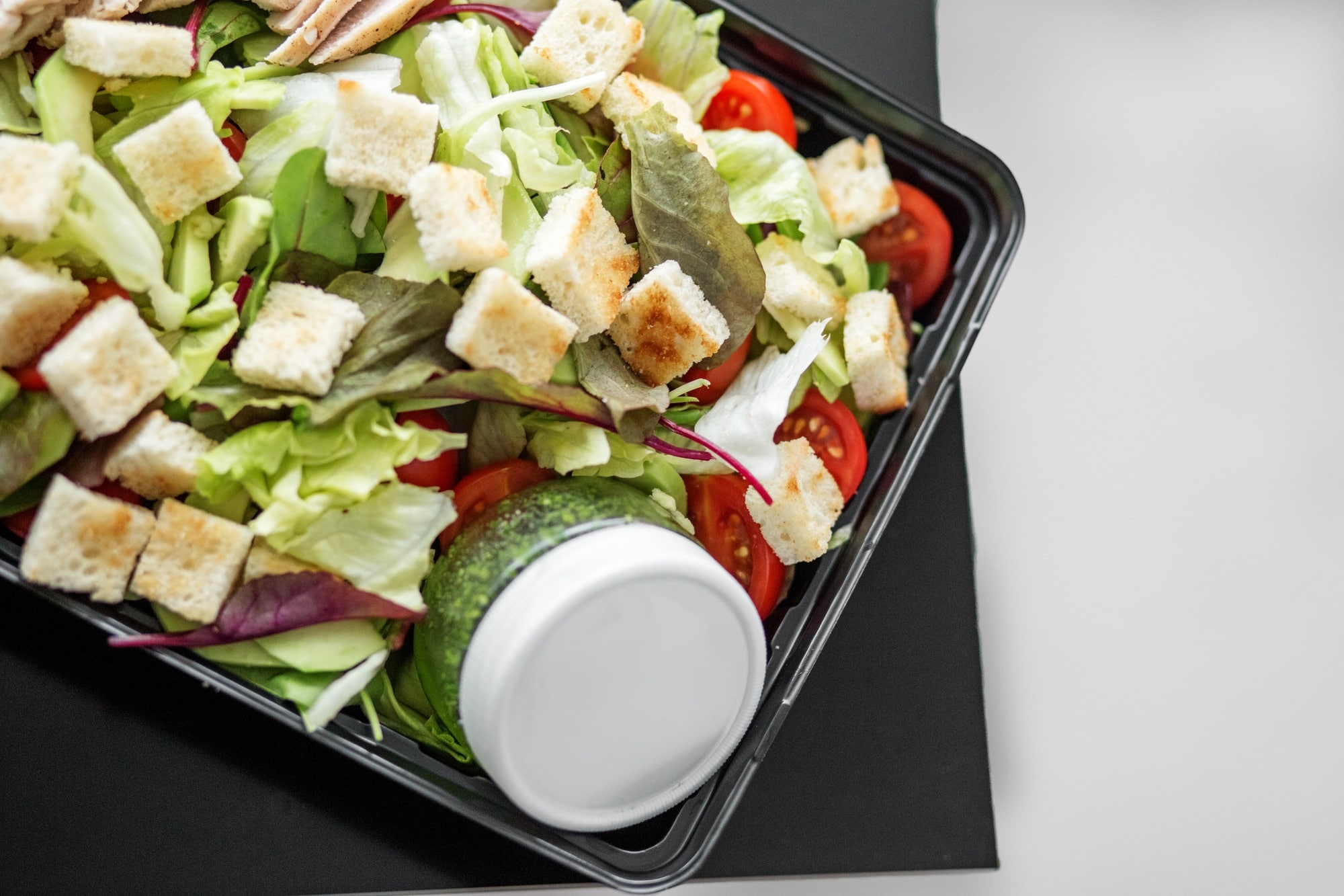 Salad with vegetables and chicken and pesto sauce in lunch box. The concept of food and food