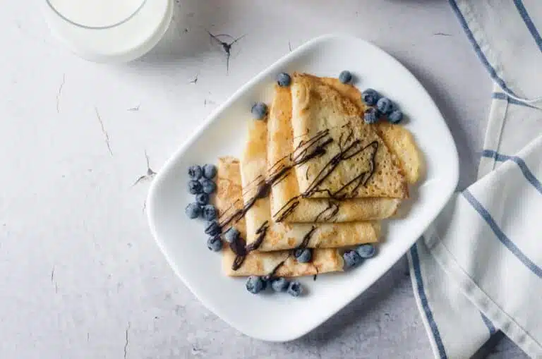 Naleśniki, which are thin homemade pancakes with berries, traditional Polish cuisine.