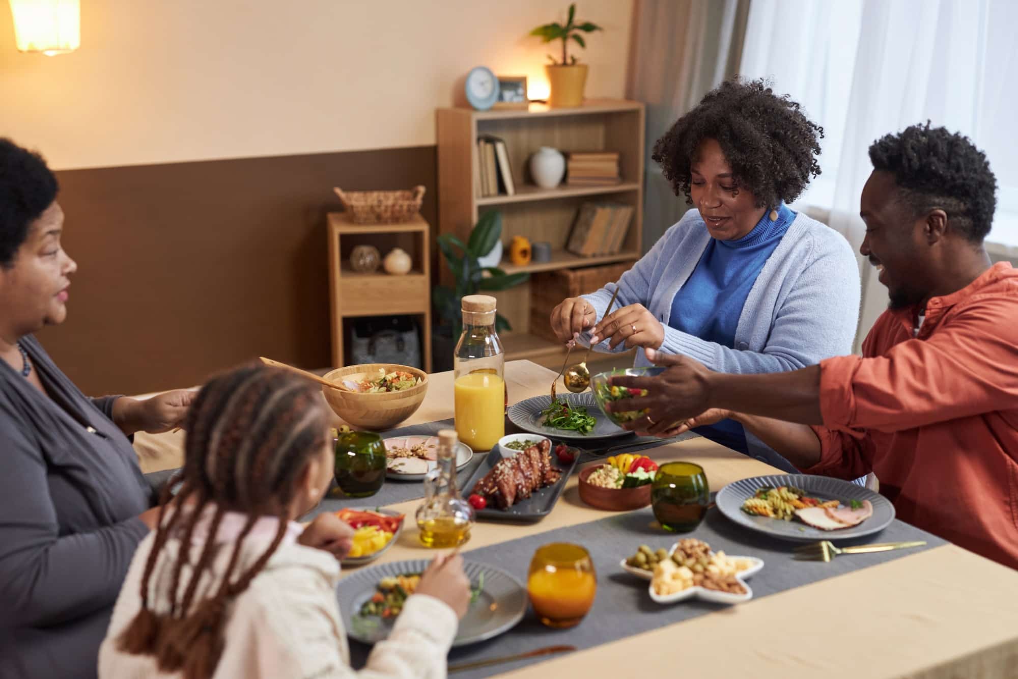 Three Generation Black Family Sharing Meal at Table