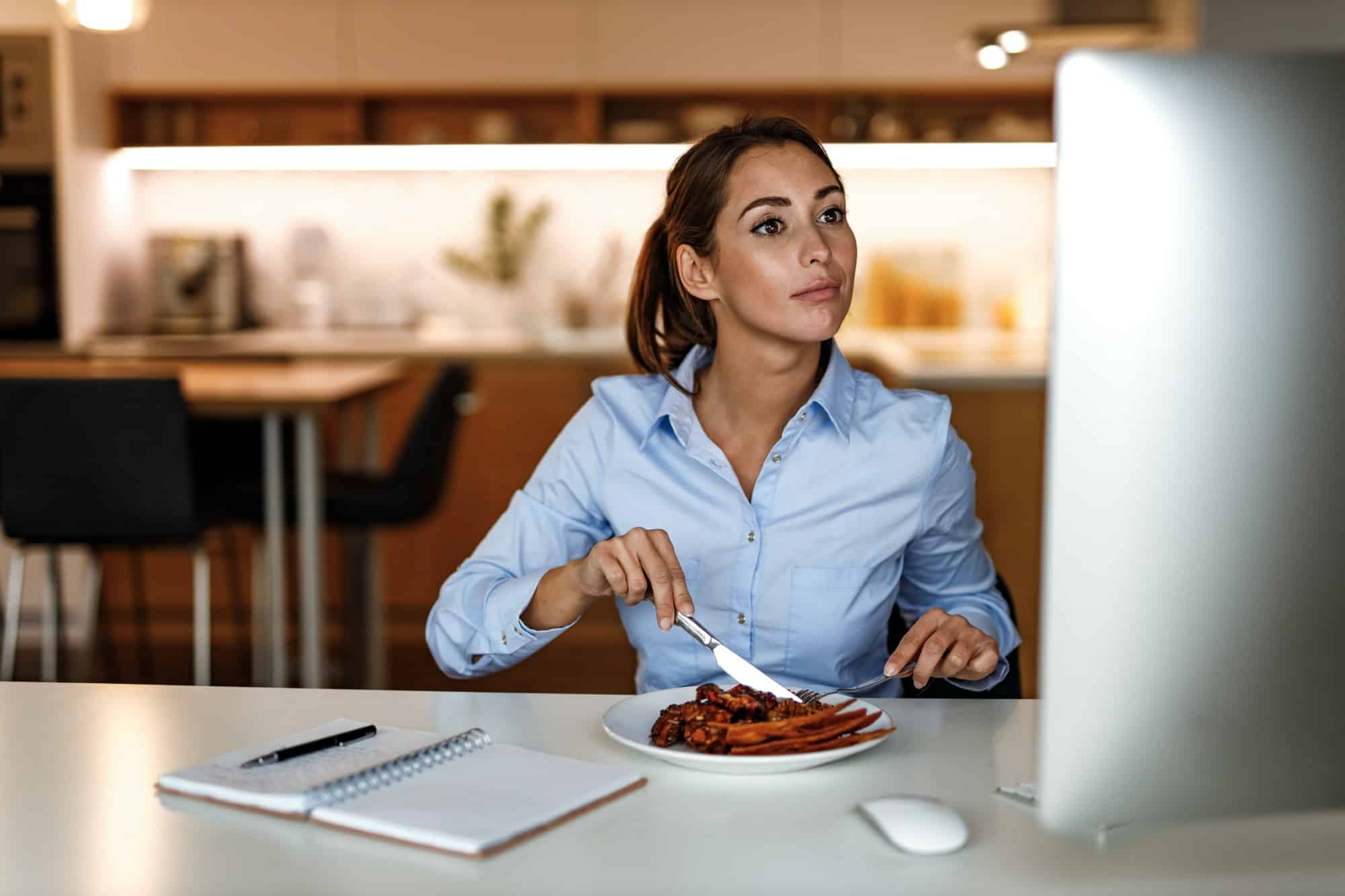 Woman at her computer having Lunch During Teleworking Meetings